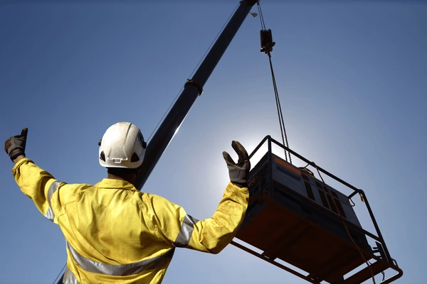 construction Support Services rigger wearing safety glove standing 600nw 1887374377